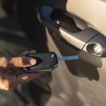 businesswoman-using-key-unlock-her-car-door